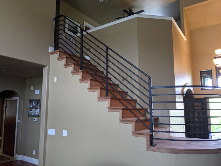 Stair treads and risers redone in Brazilian Cherry wood with custom to match new metal railing installed