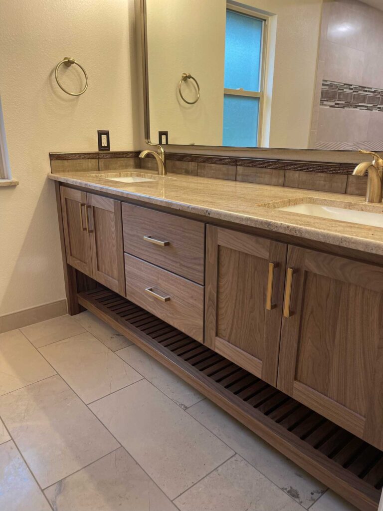 walnut bathroom vanity, two sink, with solid brass hardware, Blum concealed soft close side drawers of Baltic Birch and Blum concealed soft close hinges. Solid walnut exterior with washed finish