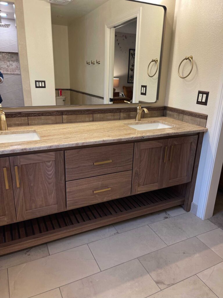 walnut bathroom vanity, two sink, with solid brass hardware, Blum concealed soft close side drawers of Baltic Birch and Blum concealed soft close hinges. Solid walnut exterior with washed finish