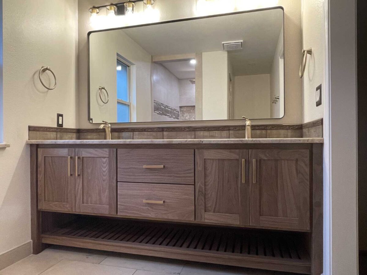 walnut bathroom vanity, two sink, with solid brass hardware, Blum concealed soft close side drawers of Baltic Birch and Blum concealed soft close hinges.  Solid walnut exterior with washed finish