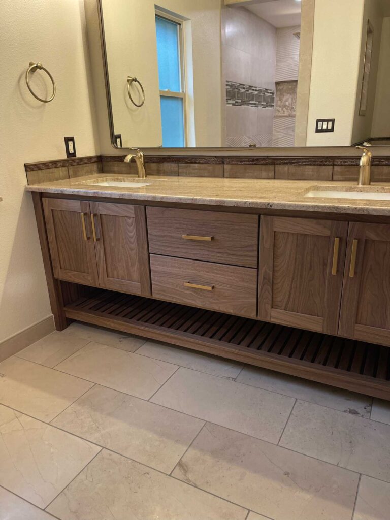 walnut bathroom vanity, two sink, with solid brass hardware, Blum concealed soft close side drawers of Baltic Birch and Blum concealed soft close hinges. Solid walnut exterior with washed finish