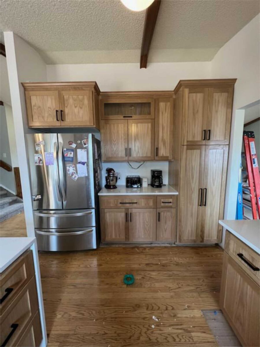 remodel of kitchen cabinetry to replace makeshift office on dividing wall, add a pantry. White oak cabinetry with general finish to reveal the natural beauty of white oak wood Increases cabient space, with pantry, with coffee bar near the refrigerator.