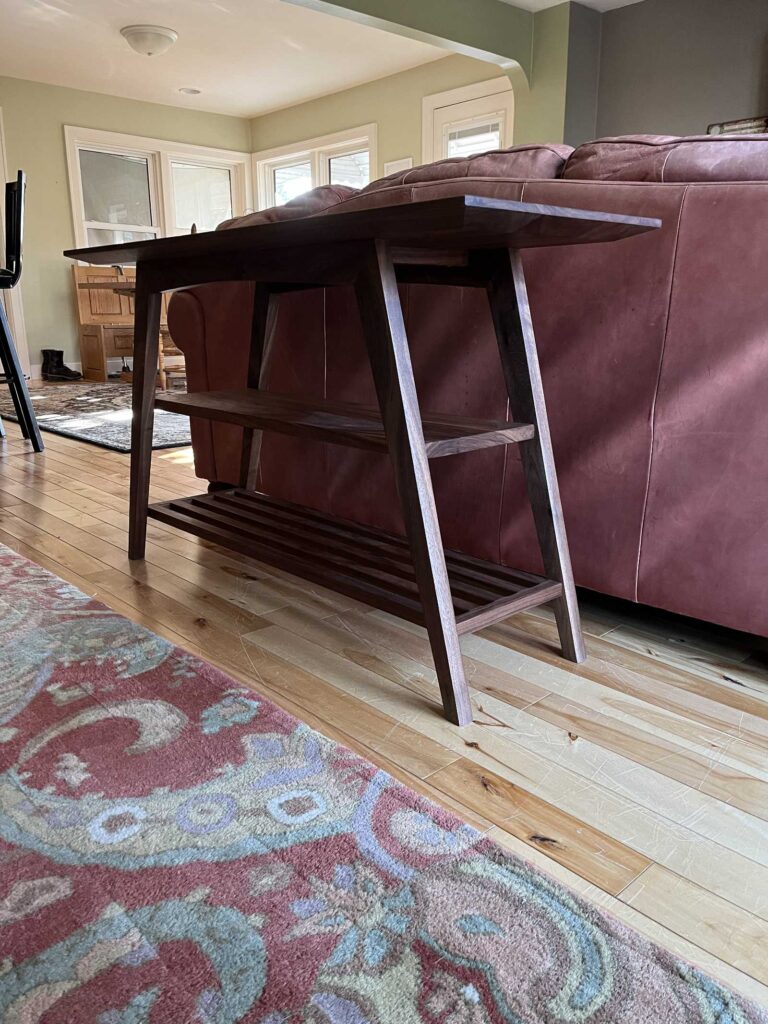 solid walnut sofa height table, with natural finish, end angle showing legs, mortise and tenon joints